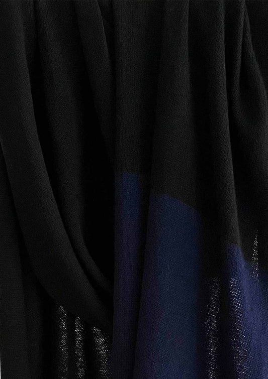 Close up detail of fine black knitted cashmere wool shawl with a navy stripe