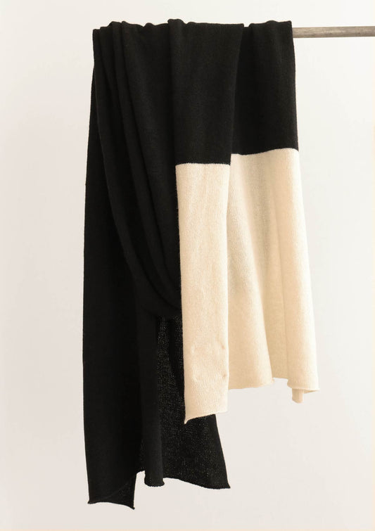 Fine knit wide scarf made from a black cashmere, yak and wool blended yarn with a cream coloured striped end
