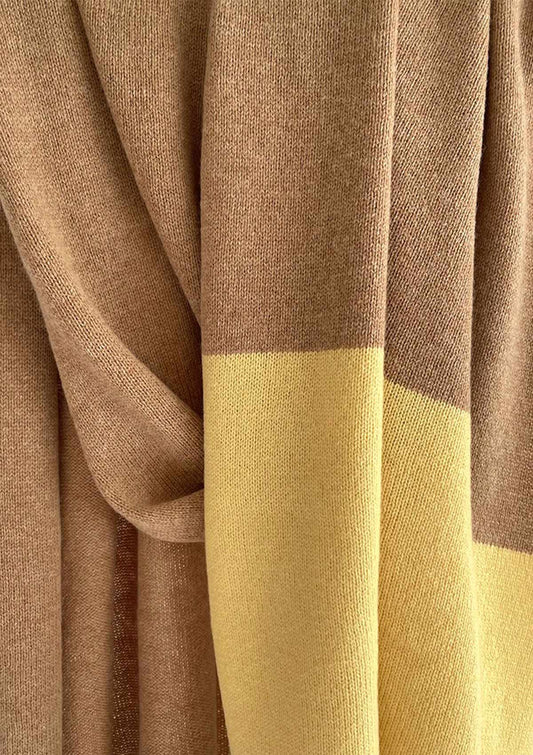 Drape detail of fine knitted wide cashmere, yak and wool scarf in beige camel with a yellow stripe