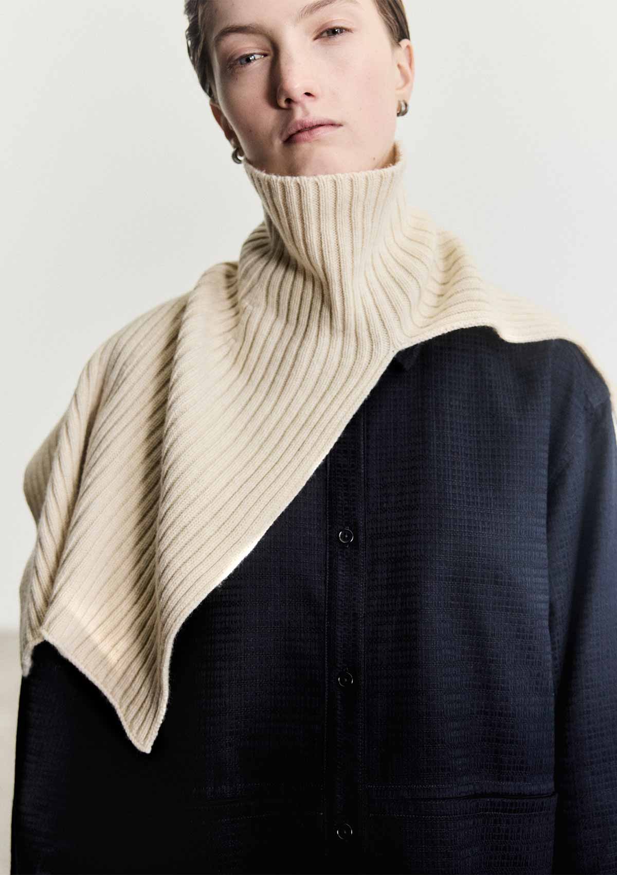 Model wearing the Leophil rib knit cape neck scarf in ivory cashmere wool