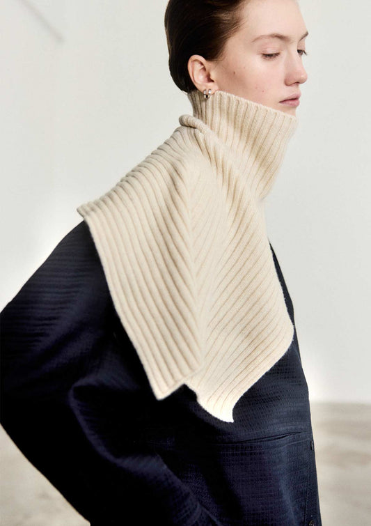 Model wearing the Leophil rib knit cape neck scarf in ivory cashmere wool