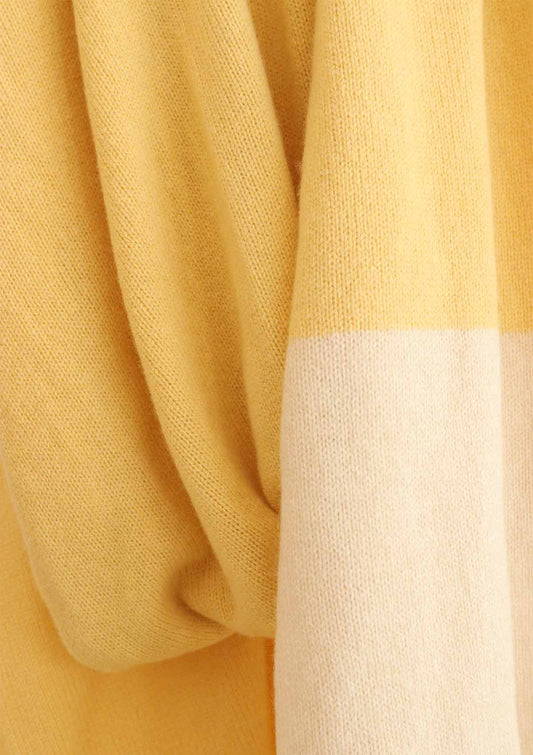 Drape detail of Women's fine knit wide cashmere, yak and wool scarf in yellow with a cream white stripe