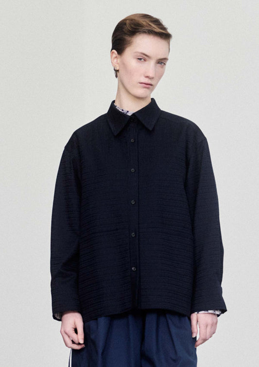 Model wearing navy textured cotton overshirt by Leophil