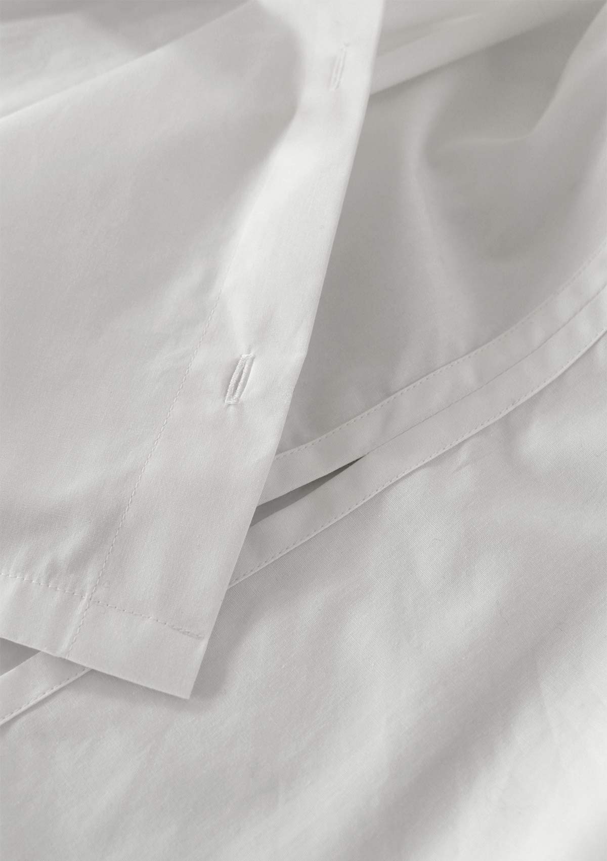 Close up of Leophil's slim white cotton Women's shirt showing french seam detail