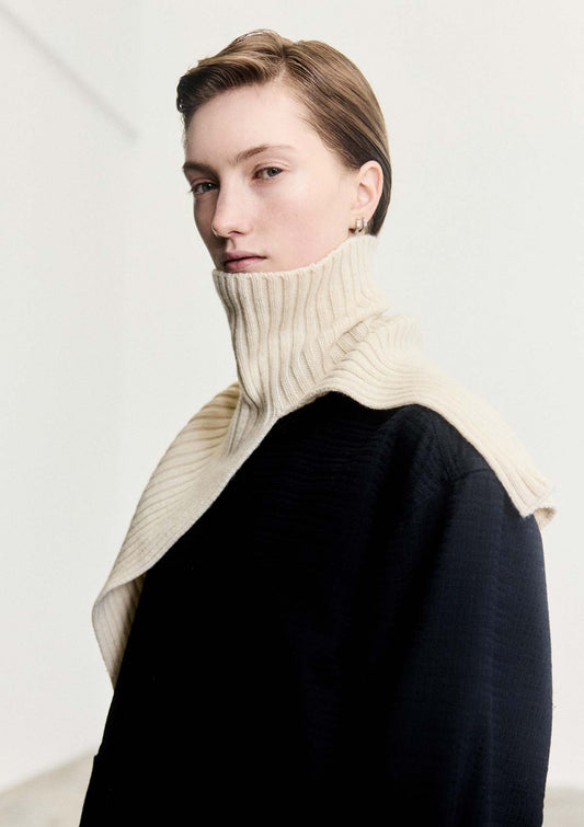 Model wearing Leophil's rib knit neck cape in ivory cashmere wool
