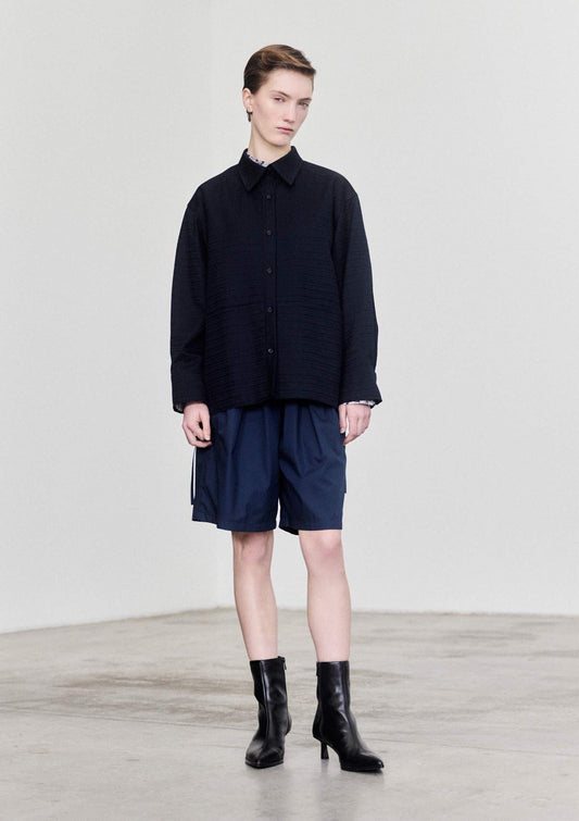 Model wearing navy textured cotton overshirt by Leophil