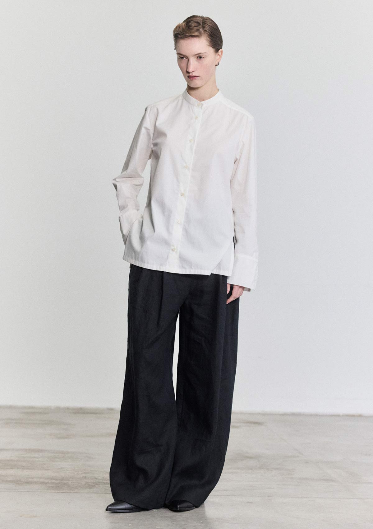 Model wearing slim white cotton women's shirt by Leophil